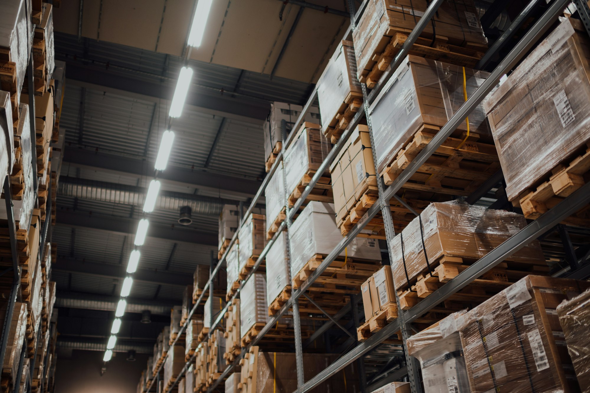 Cajas de cartón perfectamente organizadas en anaqueles metálicos de bodega
